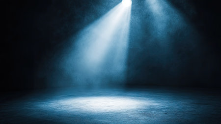 Strong directional spotlights highlighting a single object in an otherwise dark environment.の素材