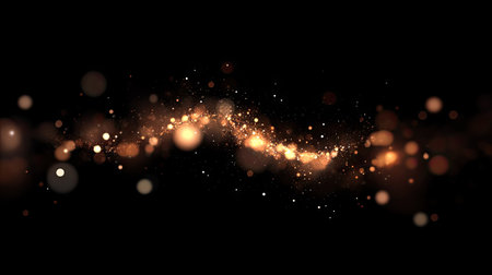 Soft, out-of-focus bokeh lights in warm white and amber tones glowing on a black night background.の素材