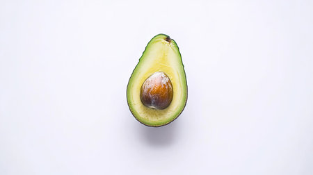 A fresh avocado sliced in half, with the pit visible, isolated on a clean white backgroundの素材