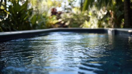 Blue pool at a contemporary villa, surrounded by tropical plants and minimalist decor, showcasing a peaceful and relaxing vibe.の素材