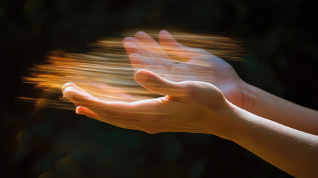 A single pair of hands clapping with motion blur, symbolizing applause in an artistic settingの素材
