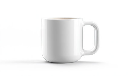 A modern white coffee cup with a handle, filled with a hot drink, isolated on a clean white background.の素材