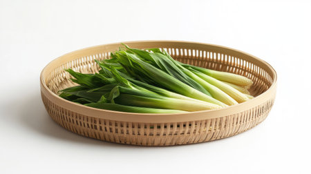 A round bamboo plate filled with fresh baby corn, showcasing its organic and natural appeal.の素材