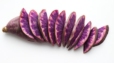 A whole purple sweet yam with thin, even slices arranged in a fan shape around it, isolated on white.の素材
