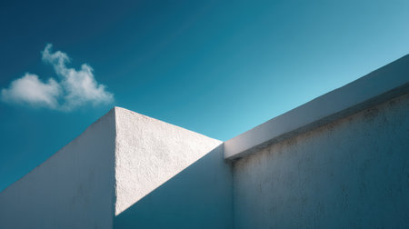 Close-up of a white concrete structure with dramatic sunlight and rich blue sky, minimalist urban aestheticの素材