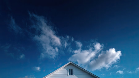 Composition showing only the white gable of a house against a saturated sky, creating contrast and harmonyの素材