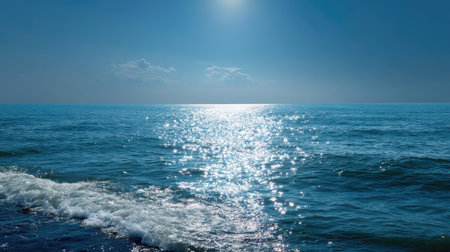 A serene view of the ocean horizon, with clear blue skies blending seamlessly into the sparkling seaの素材