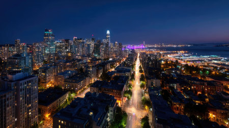 Panoramic view of a vibrant city at night from above, with streets lined with shimmering lights and skyscrapers glowing under the night skyの素材