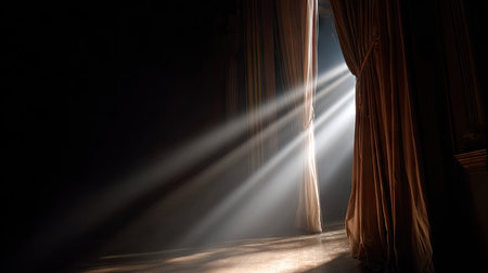 Spotlight beaming through a narrow curtain opening as anticipation builds before the showの素材