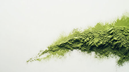 Close-up of finely ground matcha green tea powder on a white background, highlighting texture and colorの素材