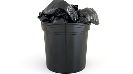 Full trash can with black garbage bag overflowing slightly, lid wide open, isolated on whiteの素材