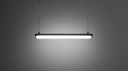 Minimalist photo of a single fluorescent light bulb hanging in the center on a gray backgroundの素材