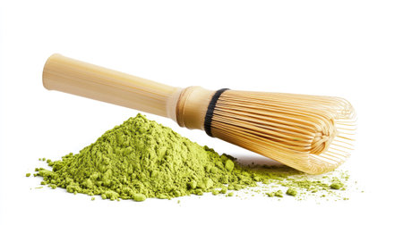 A neat pile of vibrant matcha green tea powder on a pure white background, with a bamboo scoop resting beside itの素材