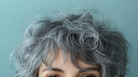 Messy gray hair on top of a head, giving a natural, unstyled look that emphasizes authenticity.の素材