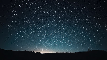 Starry night sky combined with strong spotlights creating visual contrast between natural and artificial light.の素材