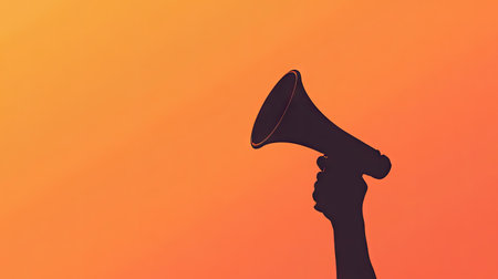 Silhouette of a hand gripping a megaphone on a gradient orange background, symbolizing powerful voice or campaign messagingの素材