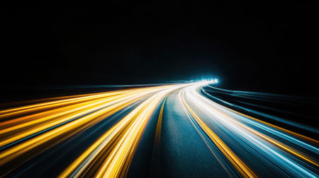 Bright light trails show the movement of vehicles on a curved road at night. The image captures the essence of speed, energy, and urban life in a dynamic setting.の素材