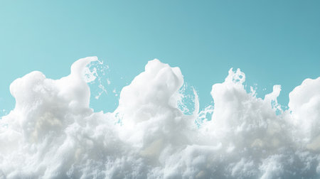 White foam edges blending seamlessly into a clear blue skyの素材