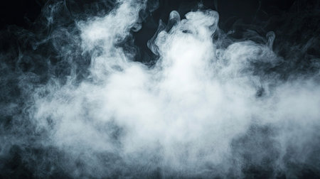 Elegant puff of white smoke with wispy, swirling patterns on a black background, highlighting its gentle movement and airy texture.の素材