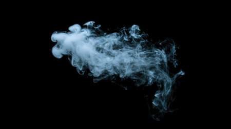 Elegant puff of white smoke with wispy, swirling patterns on a black background, highlighting its gentle movement and airy texture.の素材