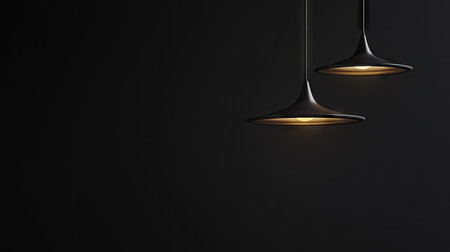 Soft glow from a hanging ceiling lamp fixture in darkness, highlighting minimal design and creating a calm atmosphere.の素材