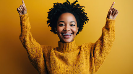 Smiling woman with a positive expression, holding clear braces confidently in her hands, showing excitement for her new smile.の素材