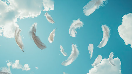 Light gray feathers floating against a deep blue sky with soft clouds, evoking freedom and tranquility in a minimalistic scene.の素材