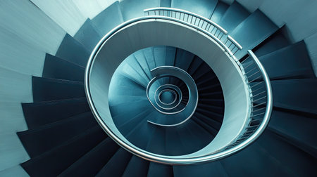 Modern staircase with stainless steel railings and black steps, creating a striking spiral effect.の素材