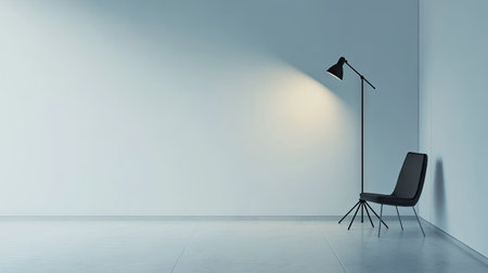 A minimal photo studio setup with a single flash lamp and clean white walls.の素材