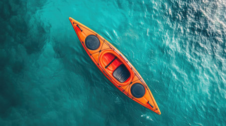 Aerial perspective of a kayak in a turquoise sea, highlighting the clean lines and natural beauty of the scene.の素材