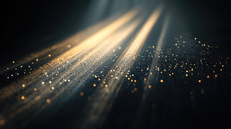 A series of sharp, parallel beams of light piercing through the darkness, illuminating floating particles and creating dramatic shadows on the black background.の素材