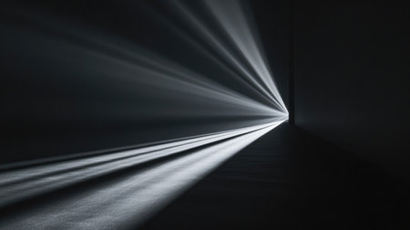 Light breaking through a pitch-black surface, with sharp, diagonal beams spreading out toward the edges of the frame, creating an intense visual contrast.の素材