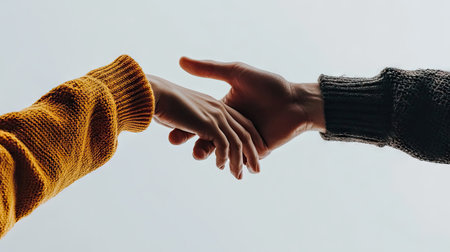 Close-up of two hands reaching towards each other on a white background, symbolizing partnership, collaboration, and mutual support. --chaosの素材