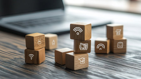 A creative arrangement of wooden blocks featuring Wi-Fi, book, and graduation cap icons, symbolizing online education, with a keyboard in the background.の素材