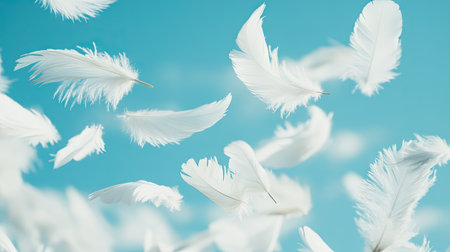Fluffy white feathers scattered and falling against a dreamy sky-blue background, creating a sense of tranquility.の素材