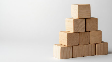 A simple arrangement of natural wooden blocks stacked in a pyramid shape, creating a minimalist composition ideal for creative and educational projects.の素材