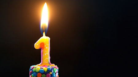 A vibrant and charming image of a single birthday candle with the number one, glowing warmly against a dark backdrop, perfect for celebrating first birthday moments.の素材