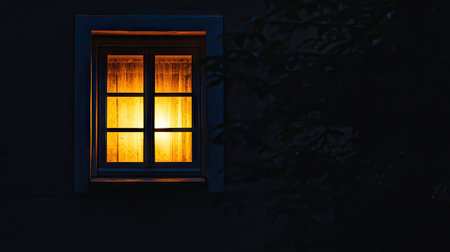 A serene window emitting a warm glow in a dark setting, creating an inviting atmosphere. The interplay of light and shadow enhances the cozy feeling of home.の素材