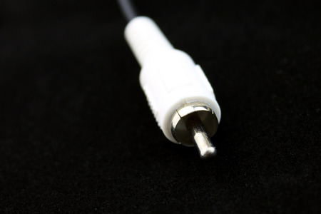 White RCA connector for audio and video closeup on black backgroundの写真素材