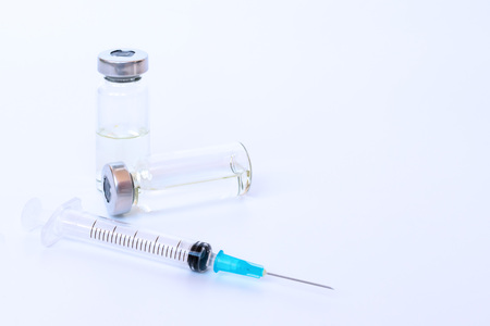 Set of syringe, two vials and tablets on white background.の写真素材