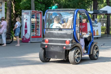 MOSCOW, RUSSIA - SEPTEMBER 02, 2018: People driving electric car in park.