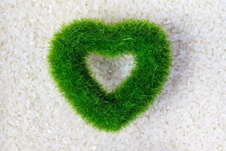 Raw white rice texture with green eco heart , organic products concept.の写真素材
