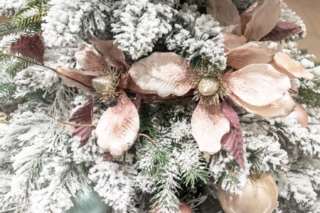 Snowy christmas tree with modern golden pastel decor close up.の写真素材