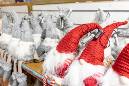 Christmas soft toy dwarfs sitting on the store shelf.