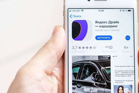 MOSCOW, RUSSIA - JANUARY 08, 2018: Hand holding Apple Iphone 7s with Yandex Drive carsharing...