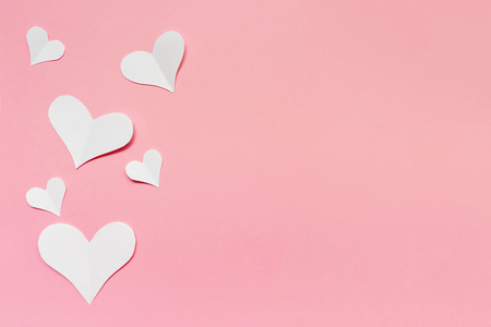 Many white paper hearts on pink background, flat lay with copy space.