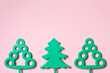 Green toy trees on pastel pink background - word environmental protection day and saving trees and forests concept with copy space.の写真素材