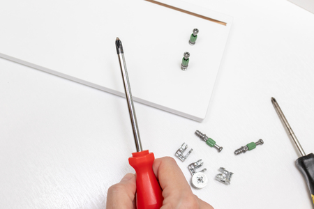 Hand holding fitting, fixing or fastener for mounting assembling furniture made of chipboard.の写真素材