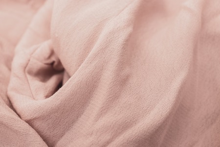 Beige pastel delicate pure textyle background of wavy viscose fabric.の写真素材