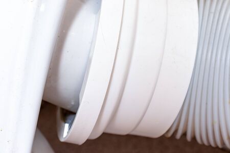 Plastic corrugated pan pipe for the toilet drain, plumbing work and installing the toilet.